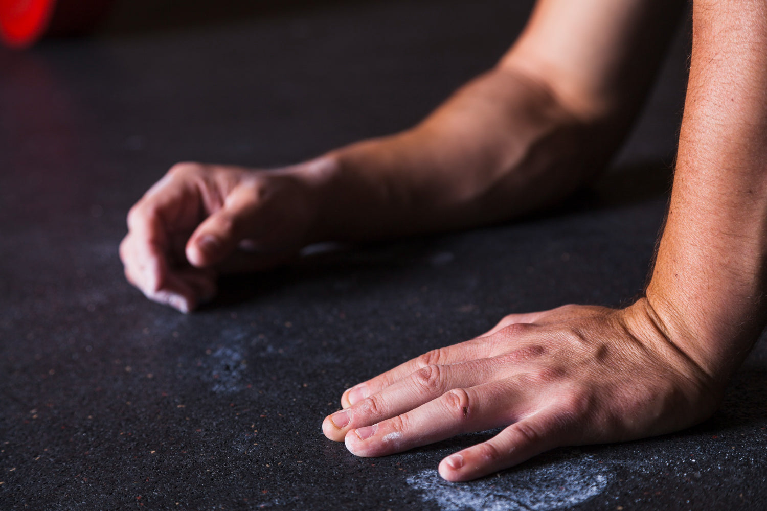 Close-up of a CrossFit athlete’s hands with chalk and skin abrasions, highlighting the importance of hand care.