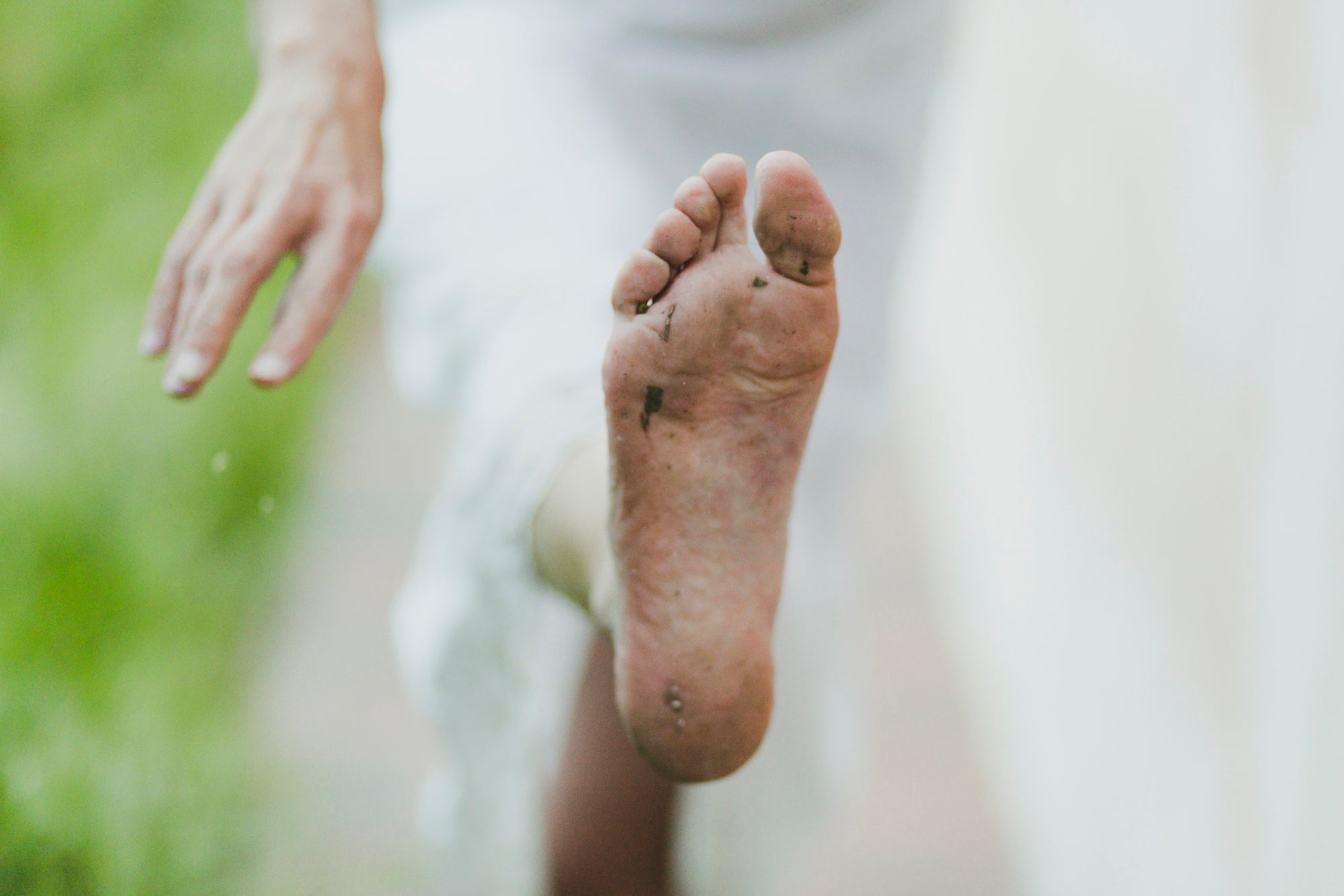 Close-up of a barefoot outdoors showing dirt and natural wear, highlighting the importance of foot hygiene to prevent smelly feet